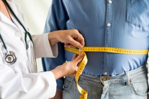 obese person being measured by a doctor