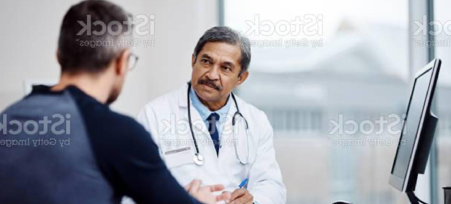 man talking to a doctor in the doctor's office